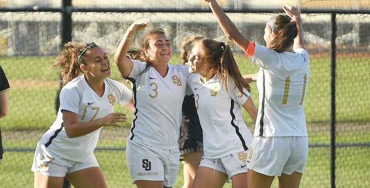 St. Joseph celebrate a first half goal by Andriana Cabral, center, during their girls soccer match at rival Trumbull.
