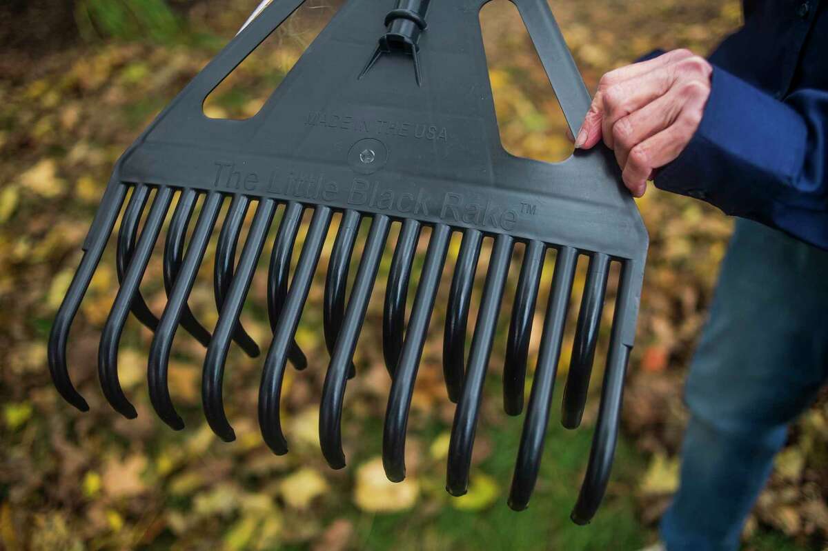 Mary Moore of Gladwin holds the Little Black Rake, a product which she and her husband David re-engineered after the original product, which they sold in their store, was discontinued. (Katy Kildee/kkildee@mdn.net)