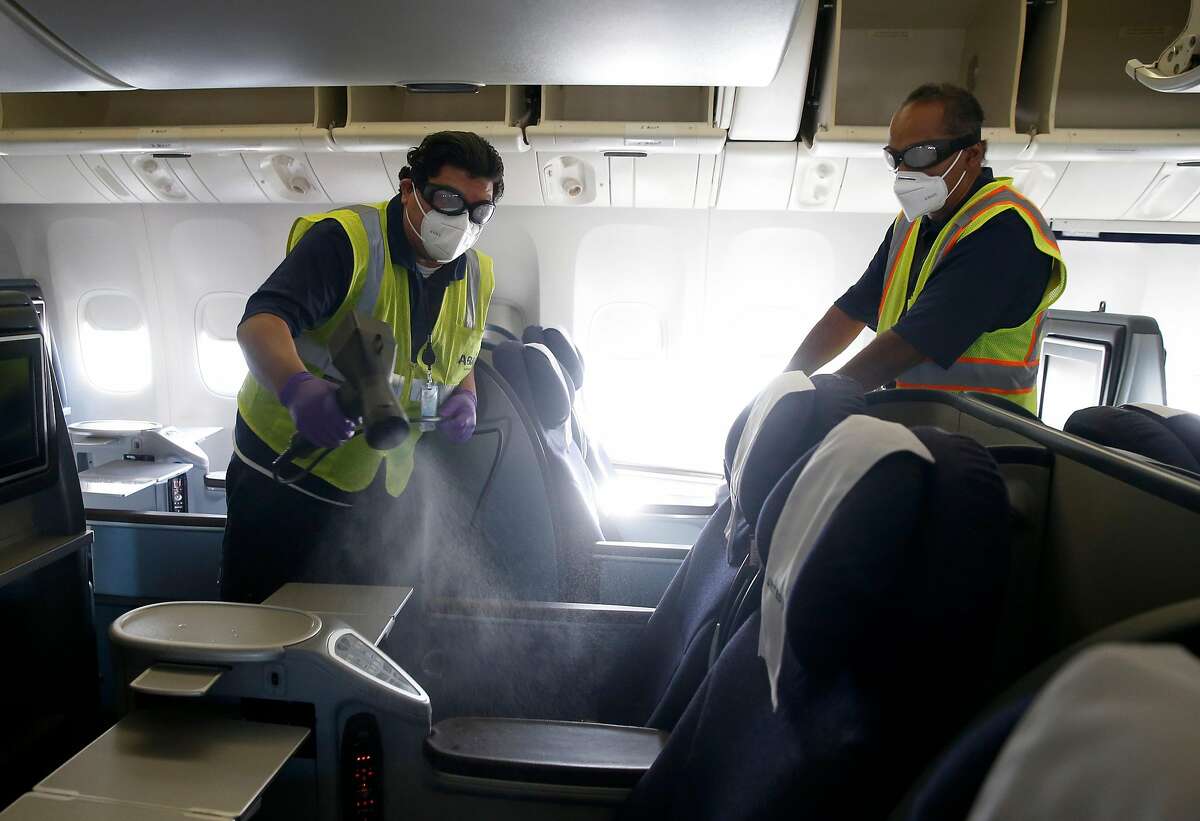 A crew sanitizes a United Airlines plane at SFO before passengers board for an October flight to Hawaii.
