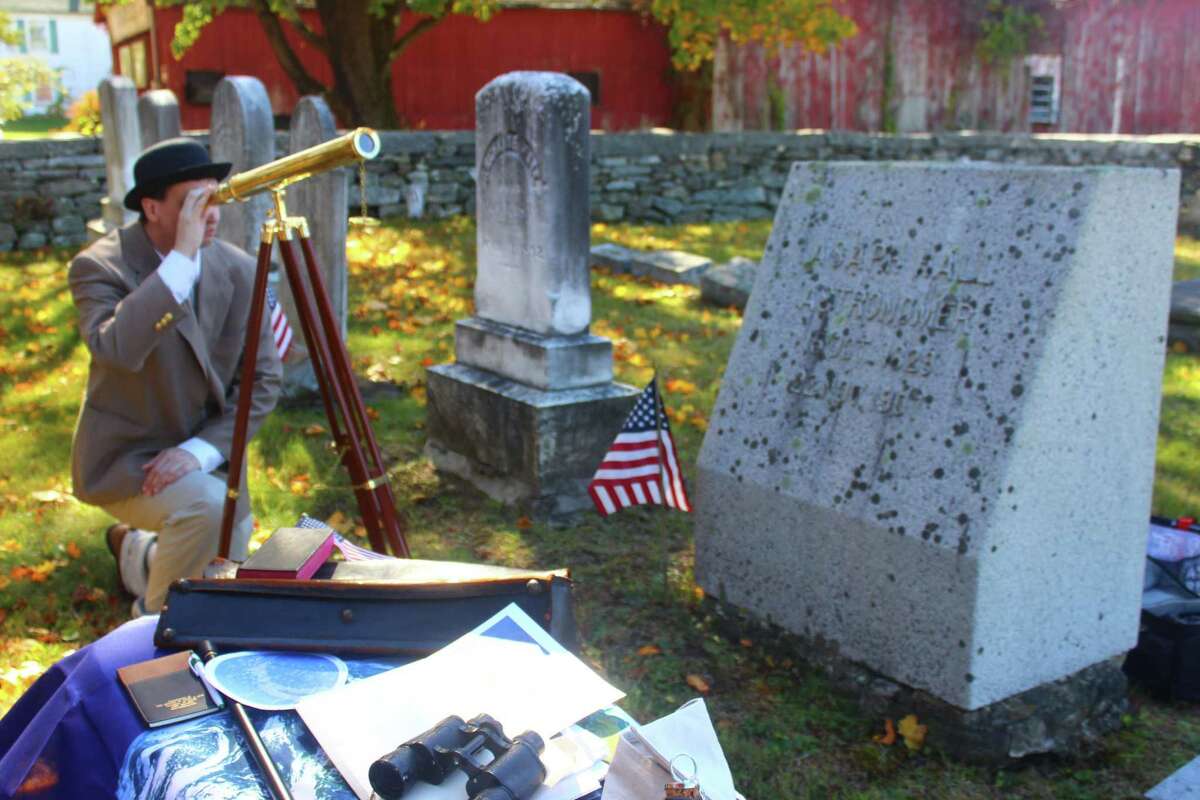 Historian and reenactor Kevin Titus dressed up as astronomer Asphus Hall and held a birthday celebration for him at his grave in Goshen Center Cemetery. Hall was the U.S. Astronomer under President Abraham Lincoln, and is credited with discovering the moons around Mars. Here, Michael Esposito takes a look through Hall’s telescope, part of a display of items belonging to the late astronomer.
