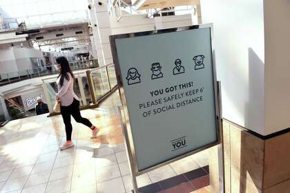 A sign at the Connecticut Post Mall in Milford encourages social distancing.