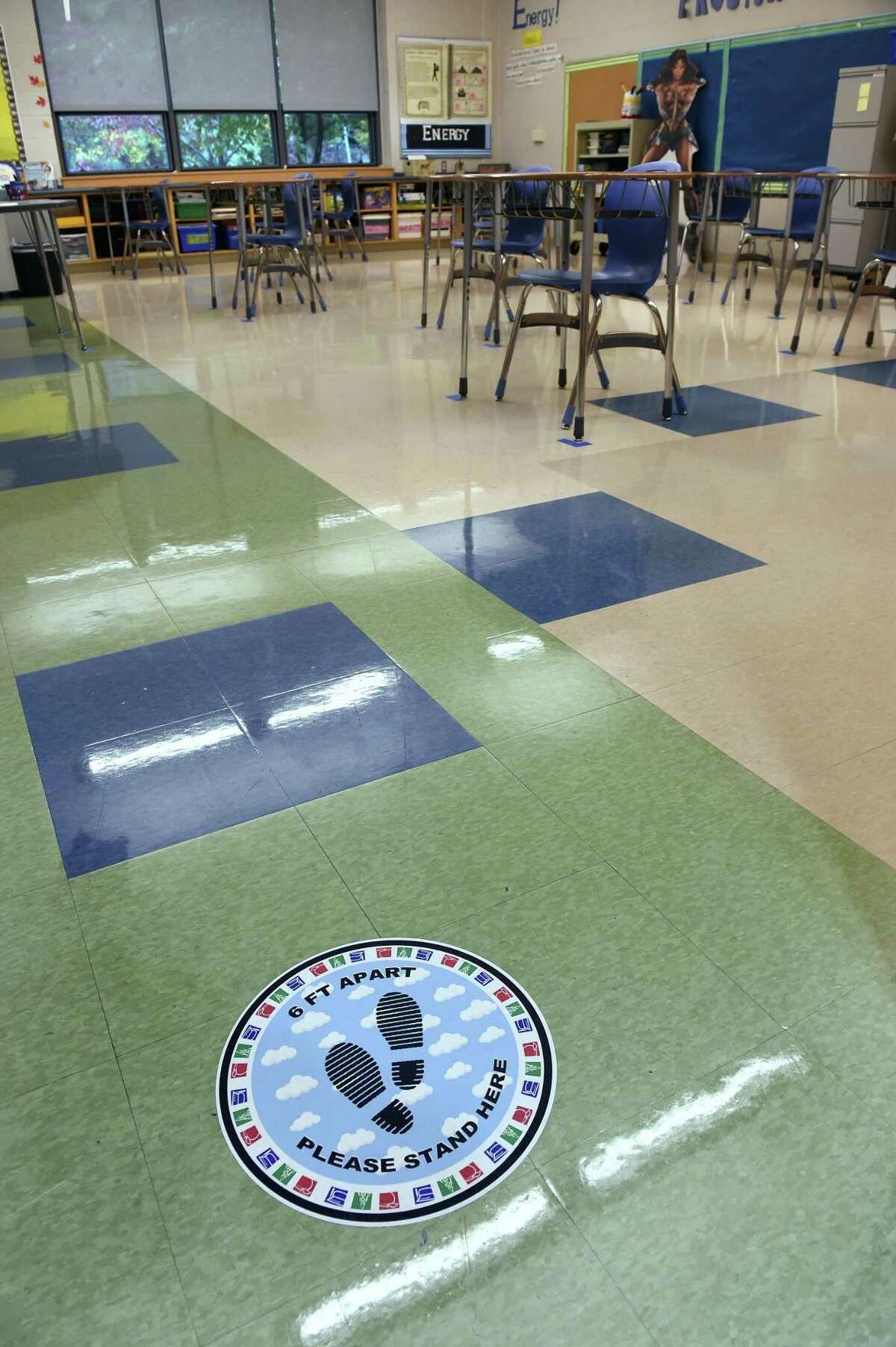 Social distancing reminders are affixed to the floors at Bishop Woods School in New Haven on October 16, 2020.