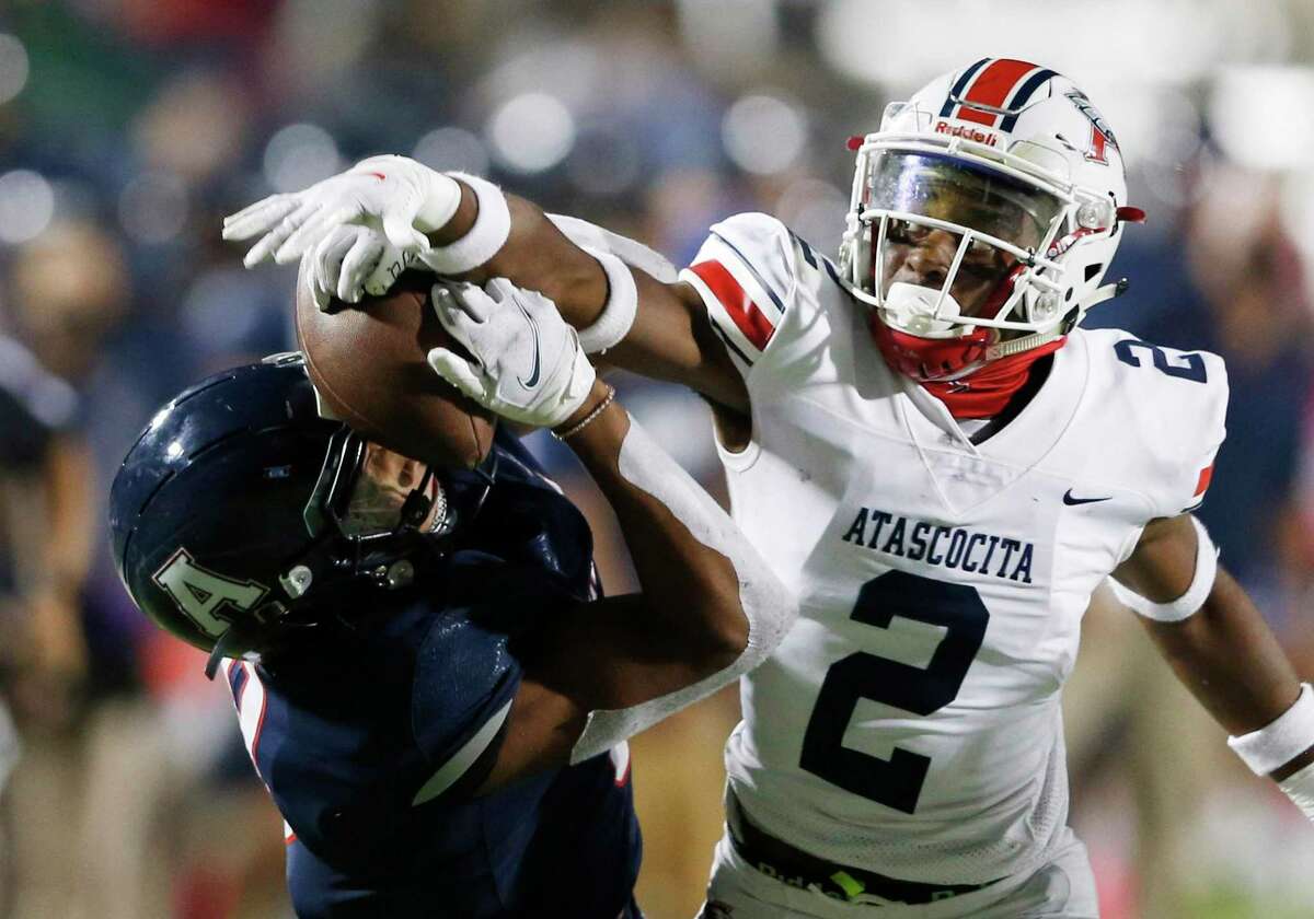 Allen's Blaine Green (8) gets the ball knocked out of his hands by Humble Atascocita's Caleb Burton (2) during the second quarter of play at Eagle Stadium in Allen, Texas on Friday, October 2, 2020. Atascocita was called for a pass interference penalty on this play. (Vernon Bryant/The Dallas Morning News)