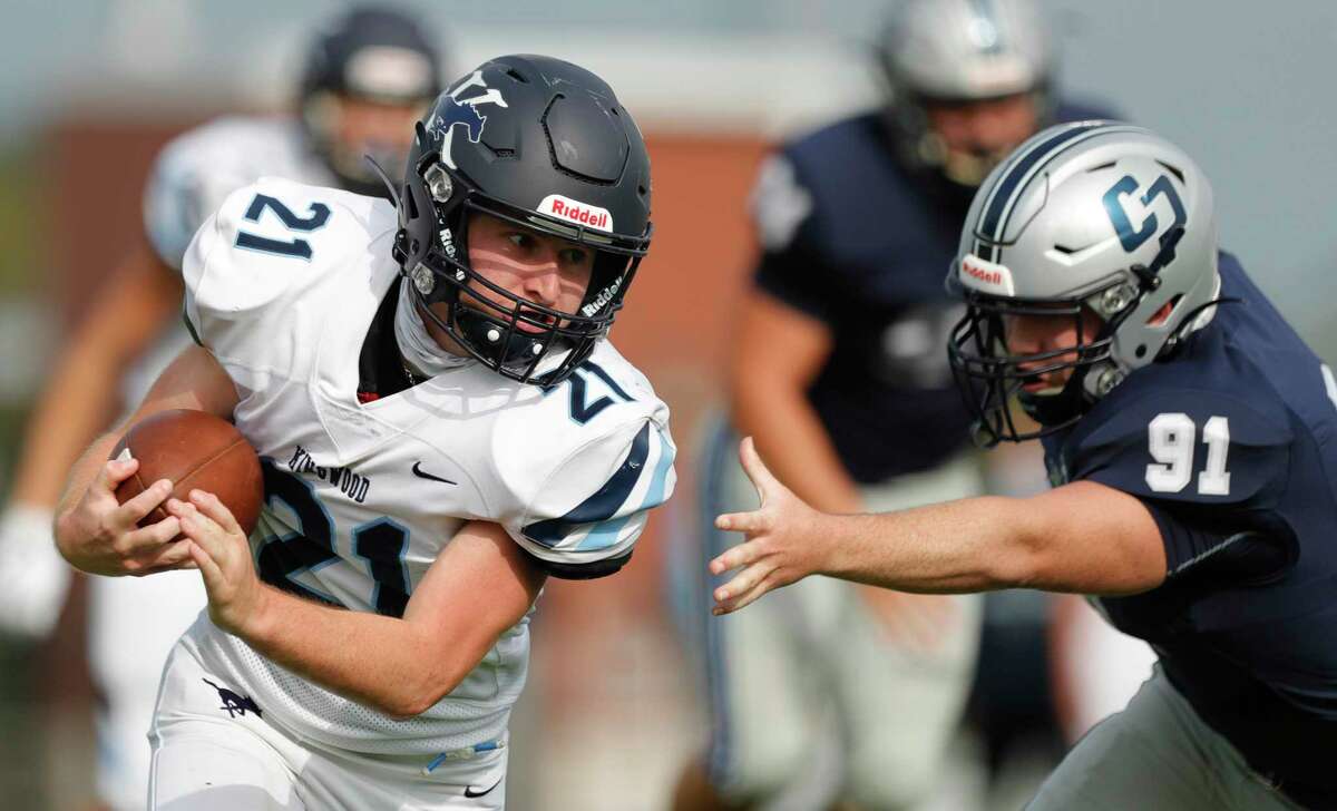 Kingwood running back Kasey Duplechin (21) runs past College Park defensive linemen Grant Ferguson (91)during the first quarter of a non-district high school football game at Woodforest Bank Stadium, Saturday, Oct. 17, 2020, in Shenandoah.