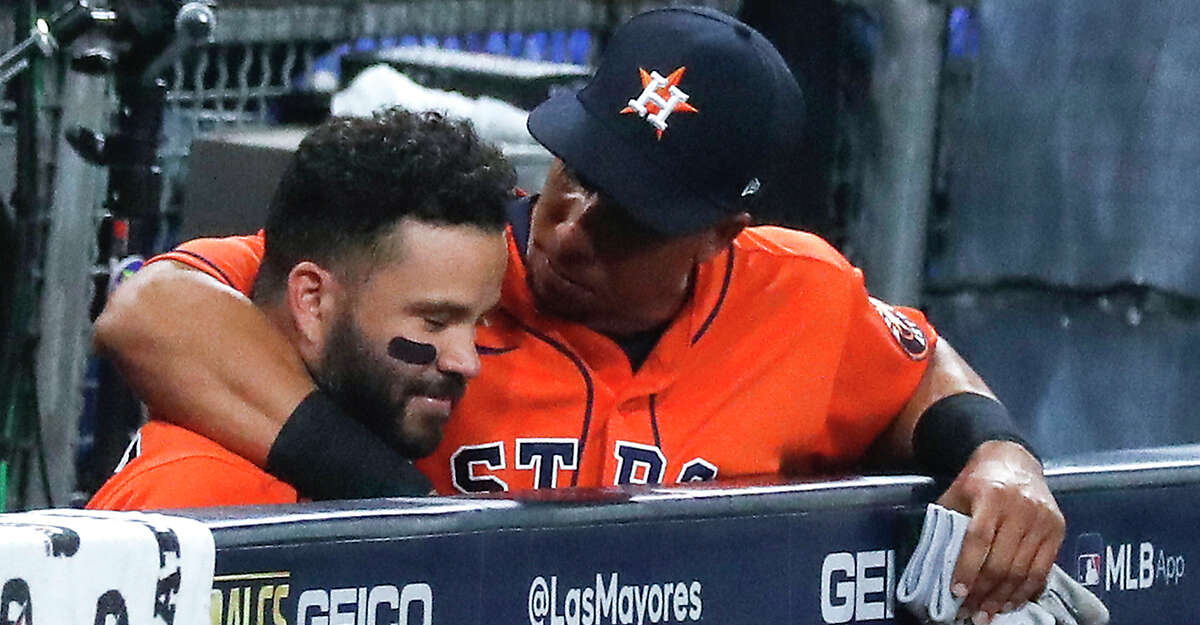 Houston Astros Jose Altuve (27) and Michael Brantley (23) embrace after the Tampa Bay Rays eliminated the Astros in Game 7 of the American League Championship Series at Petco Park Saturday, Oct. 17, 2020, in San Diego. The Rays won Game 7 4-2.