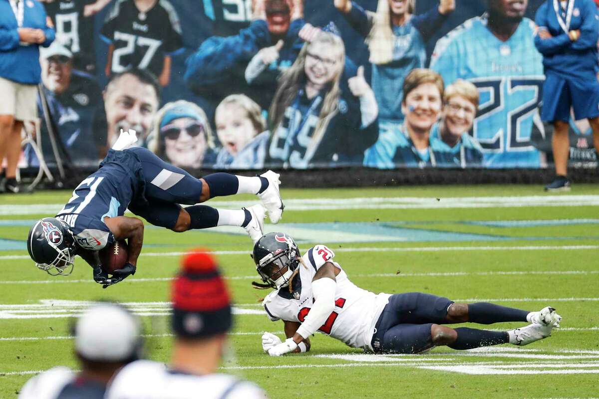 Tennessee Titans wide receiver Cameron Batson (13) is tripped up by Houston Texans cornerback Bradley Roby (21) during the first half of an NFL football game at Nissan Stadium on Sunday, Oct. 18, 2020, in Nashville.