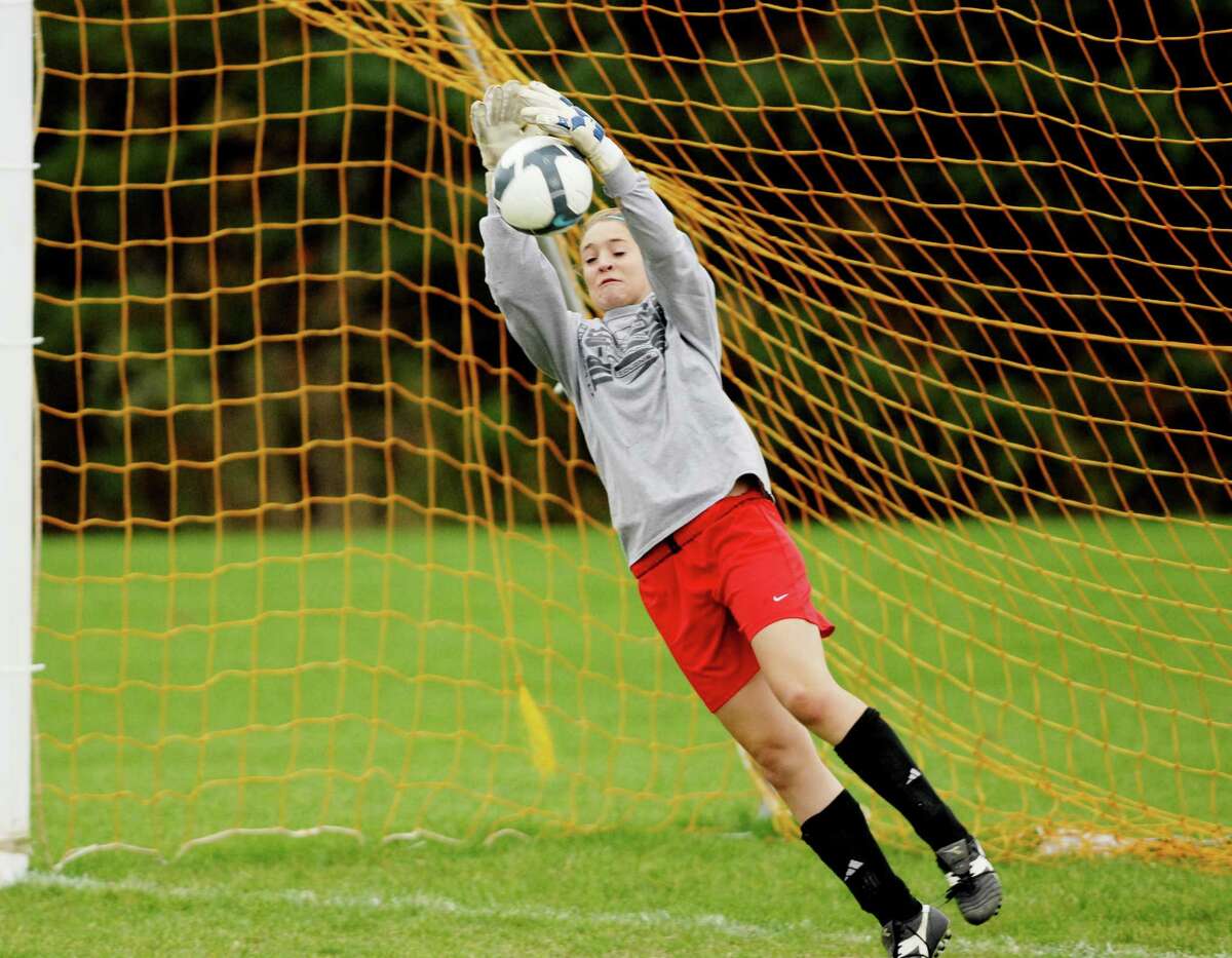 Guilderland High School girls soccer team goalie Erin Kelly, dives for a ball in the net during practice on Tuesday, Oct. 27, 2009, in Guilderland, N.Y. The Dutchmen are gearing up for Class AA playoffs. HIGH SCHOOL SPORTS (Luanne M. Ferris / Times Union)
