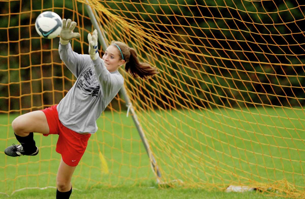 Guilderland High School girls soccer team goalie Erin Kelly, dives for a ball in the net during practice on Tuesday, Oct. 27, 2009, in Guilderland, N.Y. The Dutchmen are gearing up for Class AA playoffs. HIGH SCHOOL SPORTS (Luanne M. Ferris / Times Union)
