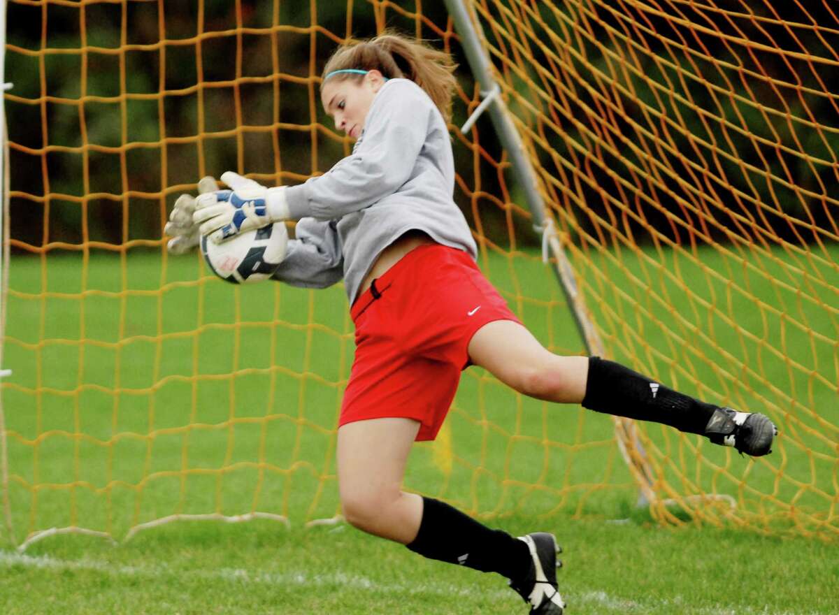 Guilderland High School girls soccer team goalie Erin Kelly, dives for a ball in the net during practice on Tuesday, Oct. 27, 2009, in Guilderland, N.Y. The Dutchmen are gearing up for Class AA playoffs. HIGH SCHOOL SPORTS (Luanne M. Ferris / Times Union)
