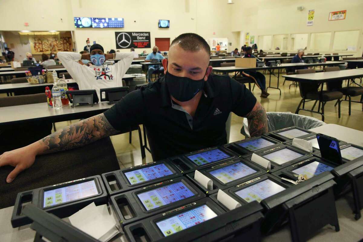 Chris Lawrence, 32, works 19 bingo computer tablets as he plays at Northeast Bingo, Wednesday Oct. 14, 2020. Bingo halls throughout San Antonio have had to adjust to the threat from the coronavirus.