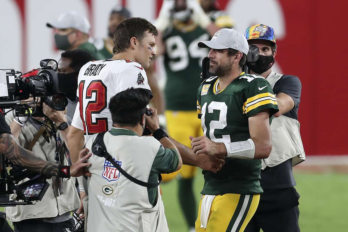 Northern California natives Tom Brady, left, and Aaron Rodgers squared off against each other in an Oct. 18 game, but Sunday’s meeting in the NFC Championship Game will be their first postseason meeting.