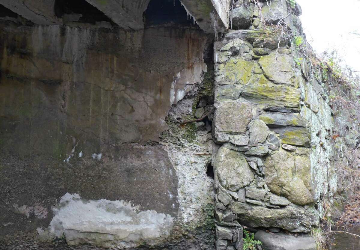 Although the Lovers Lane bridge's abutment going down to the Comstock Brook shows deterioration, portions of it will remain when the new bridge is built. Members of the Architectural Review Board said they would like the parapet up top to echo that stone work.