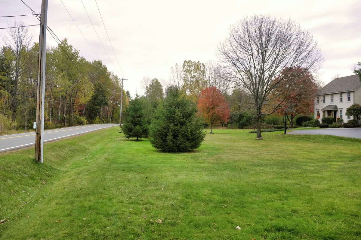 A view of Hubbs Road and a home along the road on Monday, Oct. 19, 2020, in Ballston Lake, N.Y. A solar farm is being proposed to be built off Hubbs Road in the wooded area seen on the left in the photo. Neighbors in the area say that an access road that would be created off of Hubbs Road would cause a lot of construction traffic and create unsafe conditions. Neighbors also say that once the leaves fall off the trees that the panels of the solar farm would be easily seen from their property, ruining their view and lowering their home values. (Paul Buckowski/Times Union)
