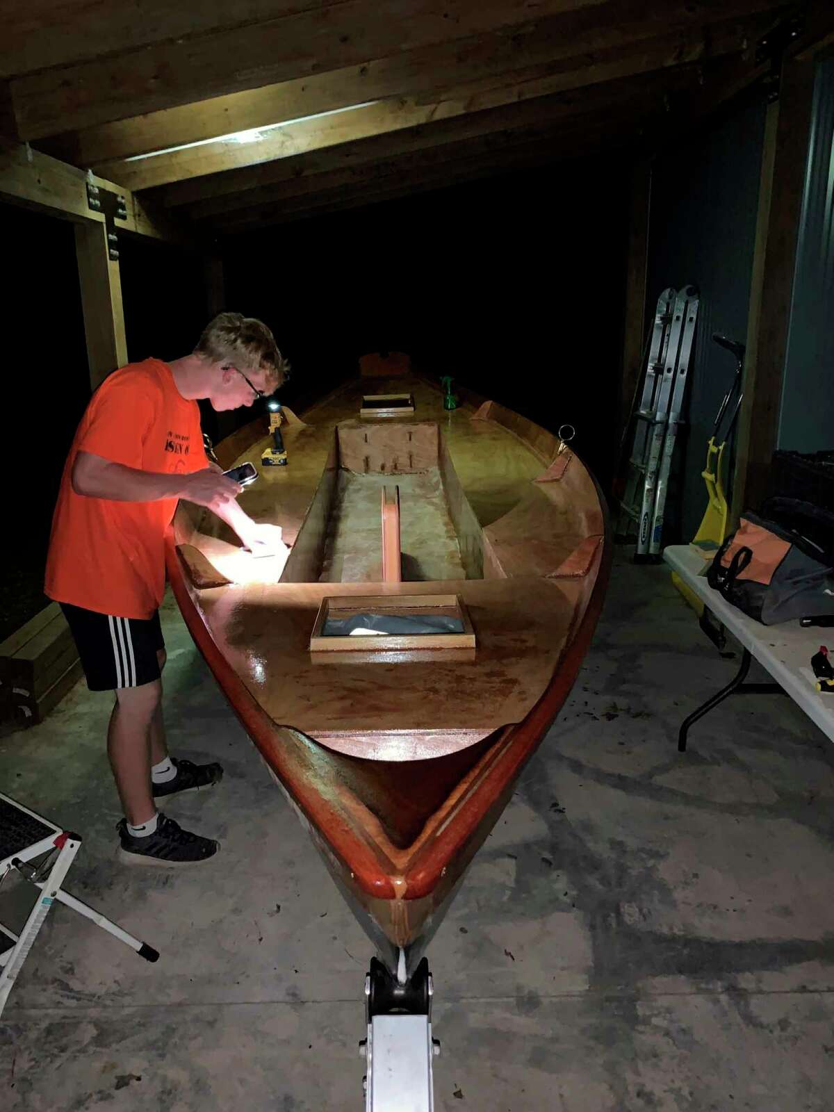 Jacob Hyde works on his sailboat. (Photo provided)
