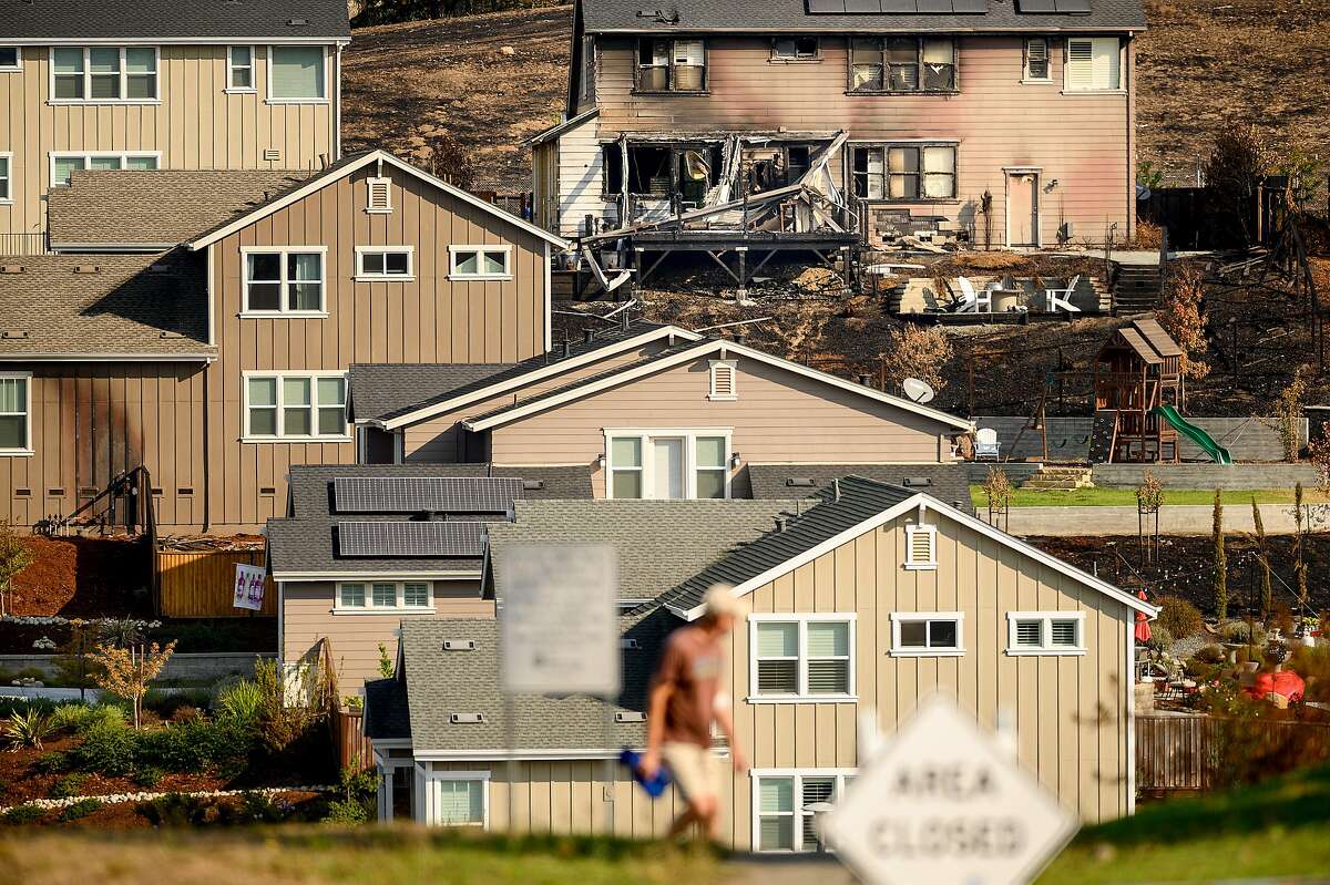A Sunhawk Dr. home scorched by the Glass Fire stands among unburned residences on Tuesday, Oct. 6, 2020, in Santa Rosa, Calif.