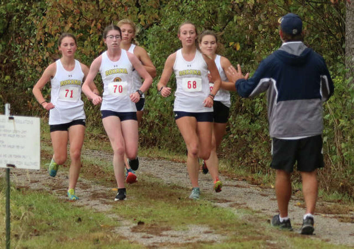 Roxana coach Scott Edwards asks his SCC Meet front-running pack of (from left) Gabrielle Woodruff, Riley Doyle, Zoey Losch, Janelynn Wirth and Keiko Palen slow their pace toward the end of the second mile of their 1-2-3-4-5 finish Monday at Southwestern High School in Piasa.