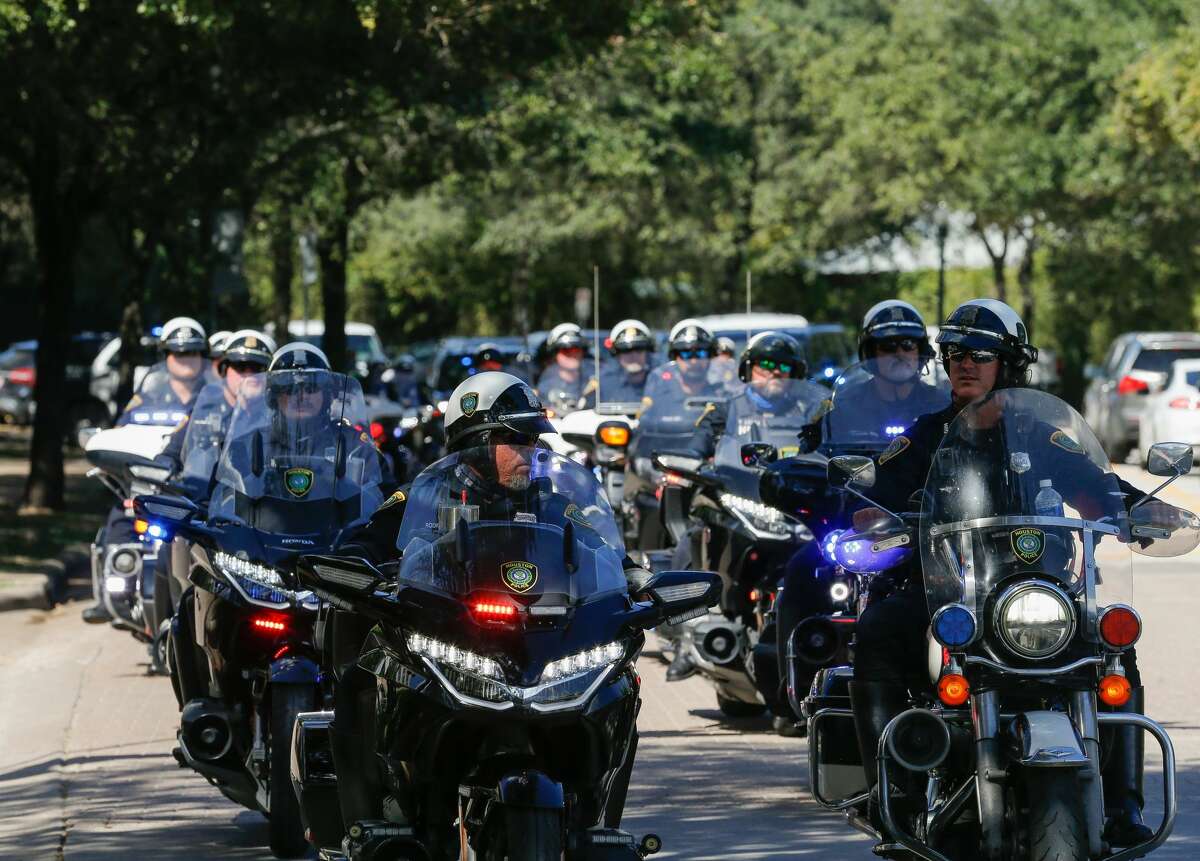 Houston Police motorcycle officers escort the body of Sgt. Harold Preston to the medical examiner's office from Memorial Hermann Hospital on Tuesday, Oct. 20, 2020, in Houston. Two officers were shot by a suspect during a domestic violence call at an apartment complex near El Rio and Holly Hall streets.