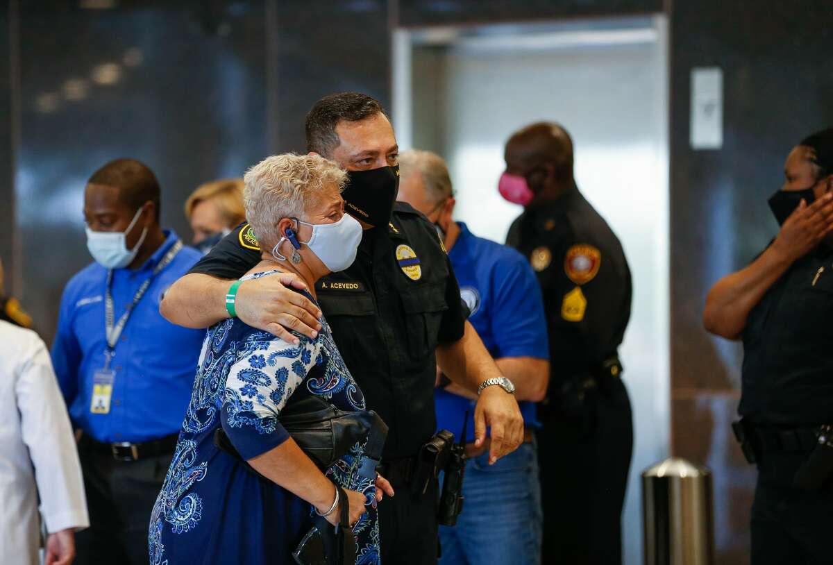 Houston Police chief Art Acevedo comforts Council Member Carolyn Evan Shabazz outside Memorial Hermann Hospital after the death of Sgt. Harold Preston on Tuesday, Oct. 20, 2020, in Houston. Two officers were shot by a suspect during a domestic violence call at an apartment complex near El Rio and Holly Hall streets.