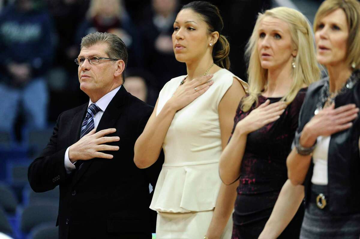 UConn coach Geno Auriemma, left, stands with assistant coaches Marisa Moseley, second from left, and Shea Ralph and associate head coach Chris Dailey, right, during the national anthem before a 2015 game. UConn has agreed to pay a total of just under $250,000 to seven women, including four members of Auriemma’s 2014 staff, after the U.S. Labor Department found they had been underpaid when compared with men in similar positions.