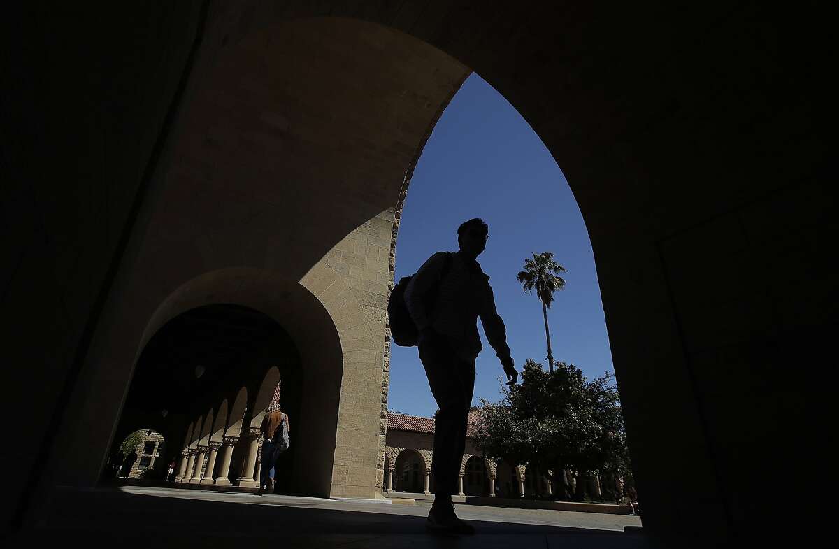 In this April 9, 2019, file photo, pedestrians walk on the campus at Stanford University in Stanford, Calif.