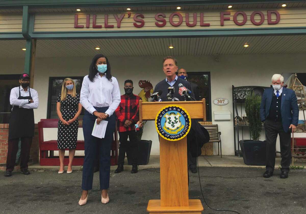The state rolled out a $50 million program to help small businesses Tuesday, Oct. 20, 2020, at Lilly's Soul Food in Windsor. Pictured are Gov. Ned Lamont speaking alongside Glendowlyn Thames, deputy commissioner of the state Department of Economic and Community Development.
