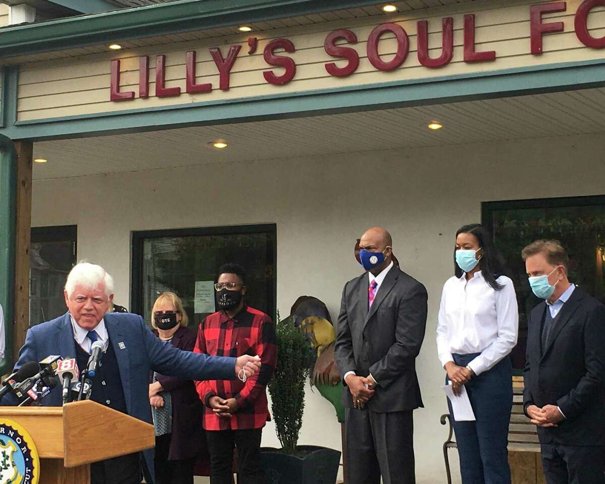 The state rolled out a $50 million program to help small businesses Tuesday, Oct. 20, 2020, at Lilly's Soul Food in Windsor. Pictured are U.S. Rep. John B. Larson, D-1, with Gov. Ned Lamont at far left; and Lamont speaking alongside Glendowlyn Thames, deputy commissioner of the state Department of Economic and Community Development.