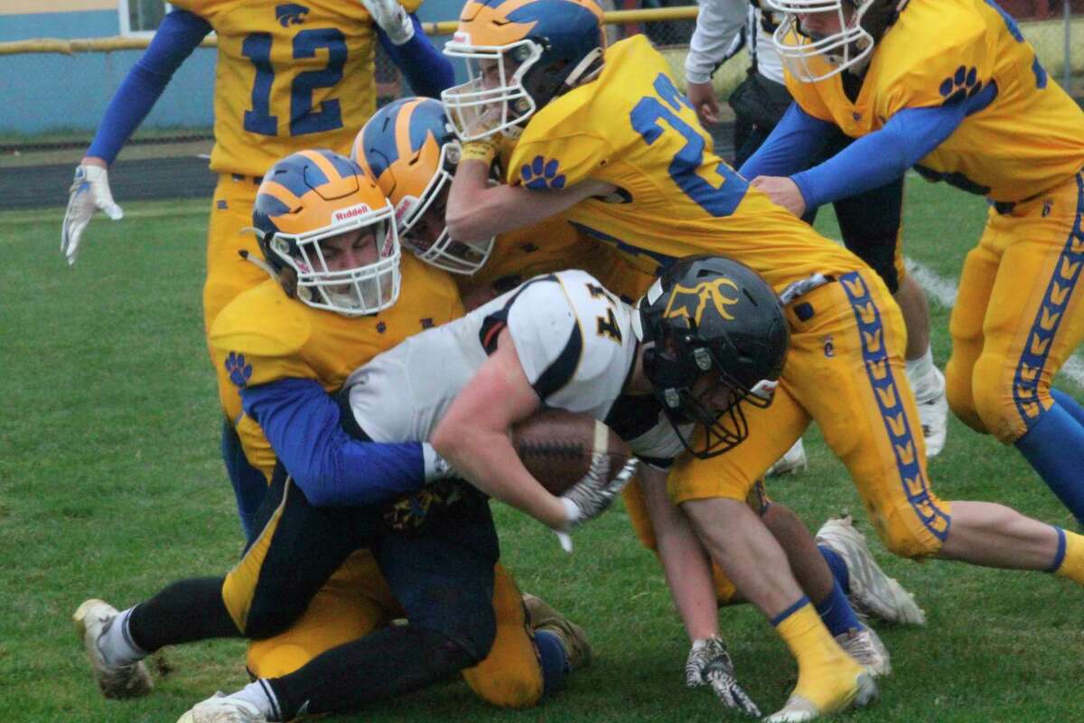Evart's Brayden Cass (23) and his teammates make the stop on Roscommon quarterback Kody Kohn during Saturday's homecoming football game. (Pioneer photo/John Raffel)