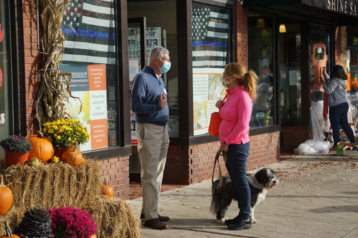 Bob Hebert, a Republican legislative candidate in Ridgefield, talks to a voter outside the GOP headquarters on Main Street in Ridgefield.