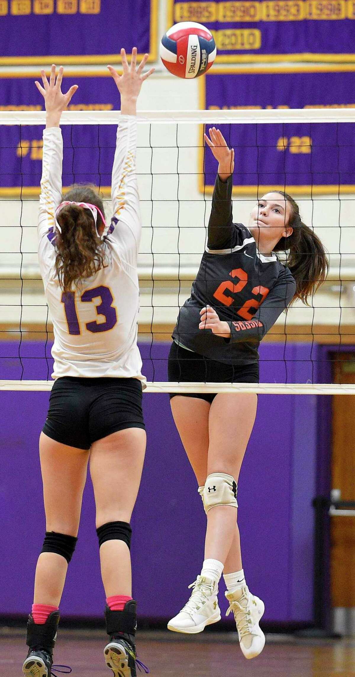 Ridgefield's Catherine Maguire spikes the ball past Westhill's Betsy Sachs (13) in a varsity girls volleyball match on Wednesday, Oct. 24, 2018 in Stamford, Connecticut.