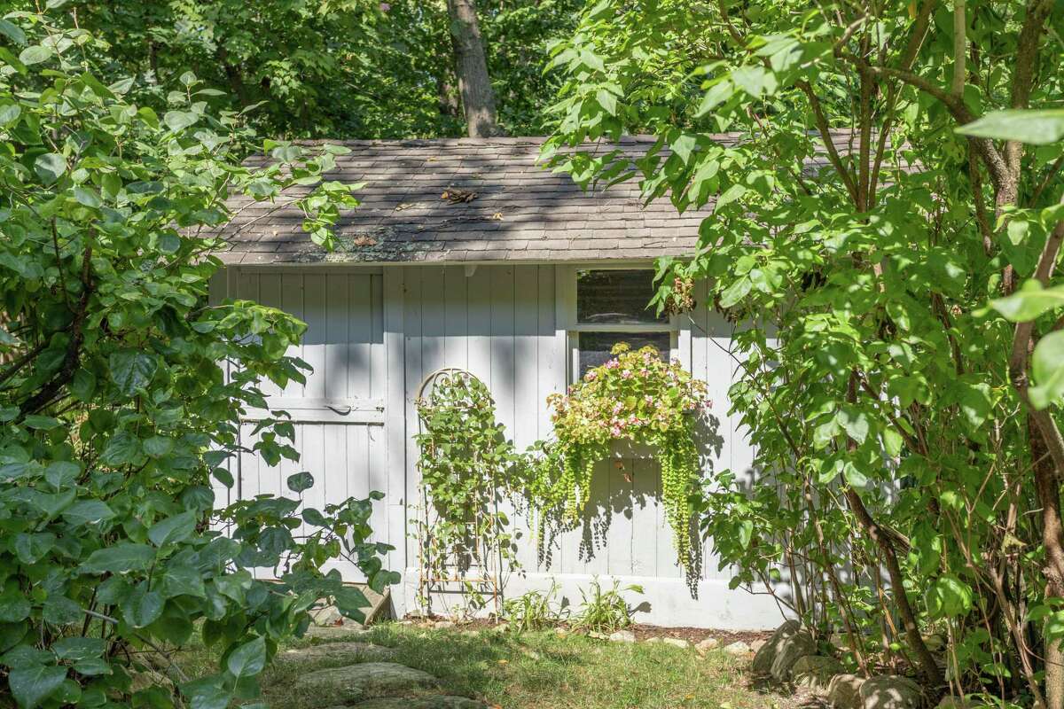 A charming tool shed could be converted into a potting shed.