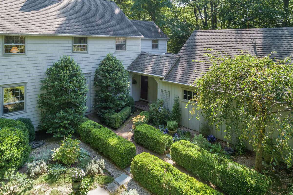 Attractive landscaping, including manicured shrubbery, line the red brick path to the covered front entrance. They have also appreciated the convenience of their home's location, only two minutes from the public library, town offices and award-winning public schools in Weston center and about 10 minutes from neighboring Westport. Yet they experience