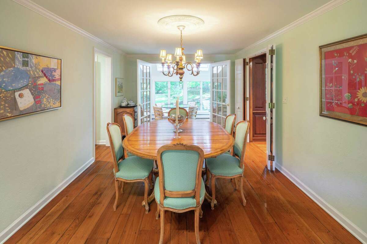 There are two sets of French doors in the formal dining room; one to the kitchen and the other to the sun room.