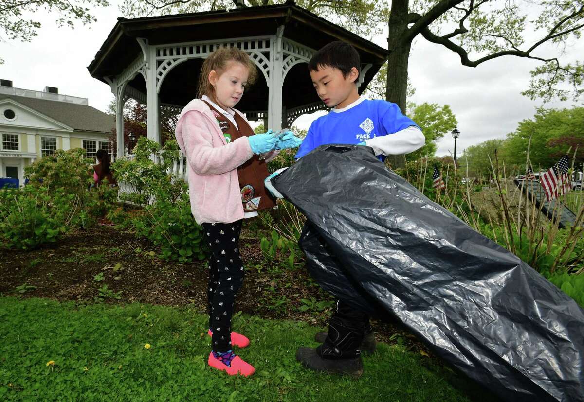 Brownie with Wilton Troop 50734, Ruth Frisbee and Cub Scout with Pack 22, Alex Shiue participate in Wilton's Townwide Cleanup last year. Cub Scouts participate in a number of community service events.