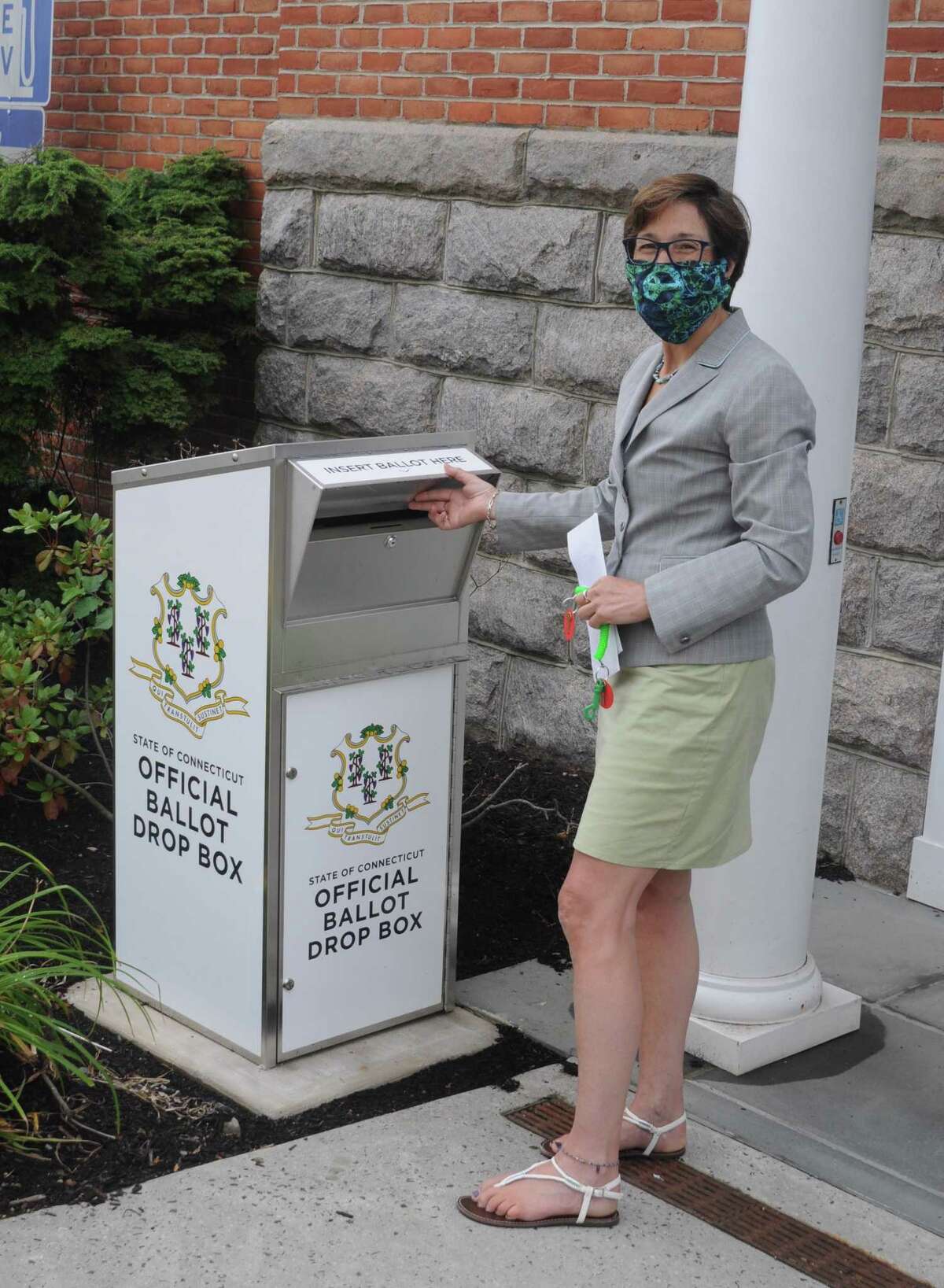 Town Clerk Wendy Lionetti shows off the ballot drop box on Bailey Avenue near a side entrance to town hall.
