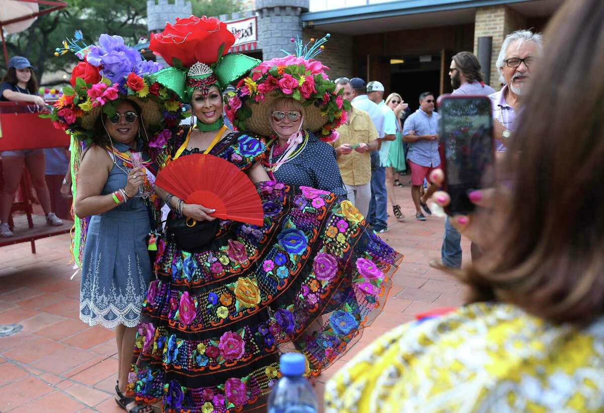 Tina Zavala, center, goes all festive in her outfit as she and her friends Paula Gallegos-Denton, left, and Marci Aguirre attend 2018’s Night in Old San Antonio at La Villita. In the wake of Fiesta — and NIOSA — being canceled this year, the Conservation Society is holding a more modest event, the Fall Heritage Festival.