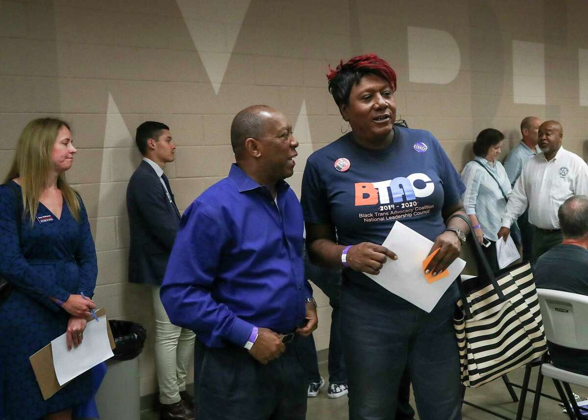Houston Mayor Sylvester Turner talks with Monica Roberts, who is on Turner's LGBT advisory board, at the Houston GLBT Political Caucus on Saturday, Aug. 3, 2019, in Houston. Turner won the caucus' support in 2015.