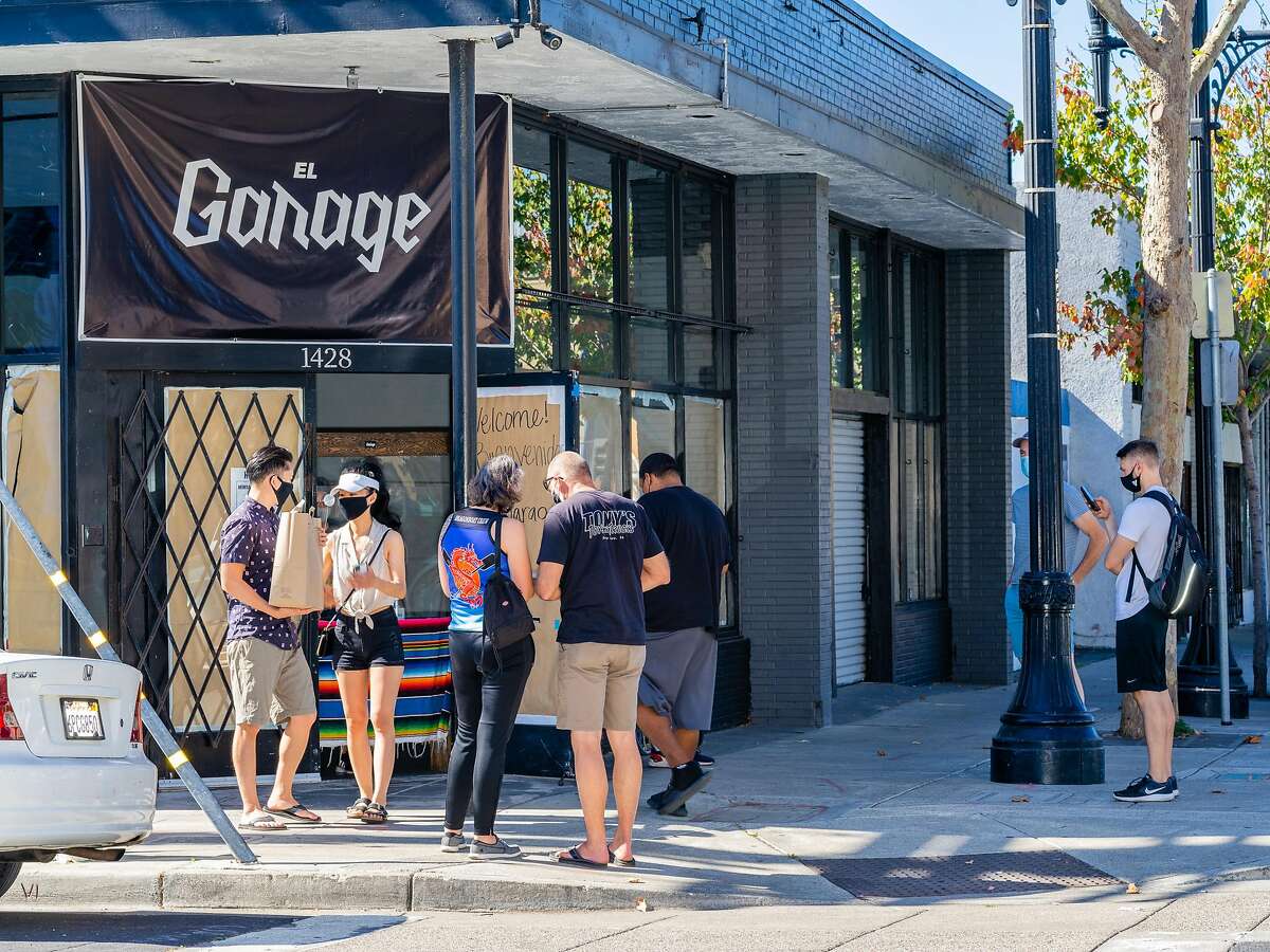 Customers waiting for pick up orders at El Garage in Richmond, Calif. on Saturday, October 17, 2020.