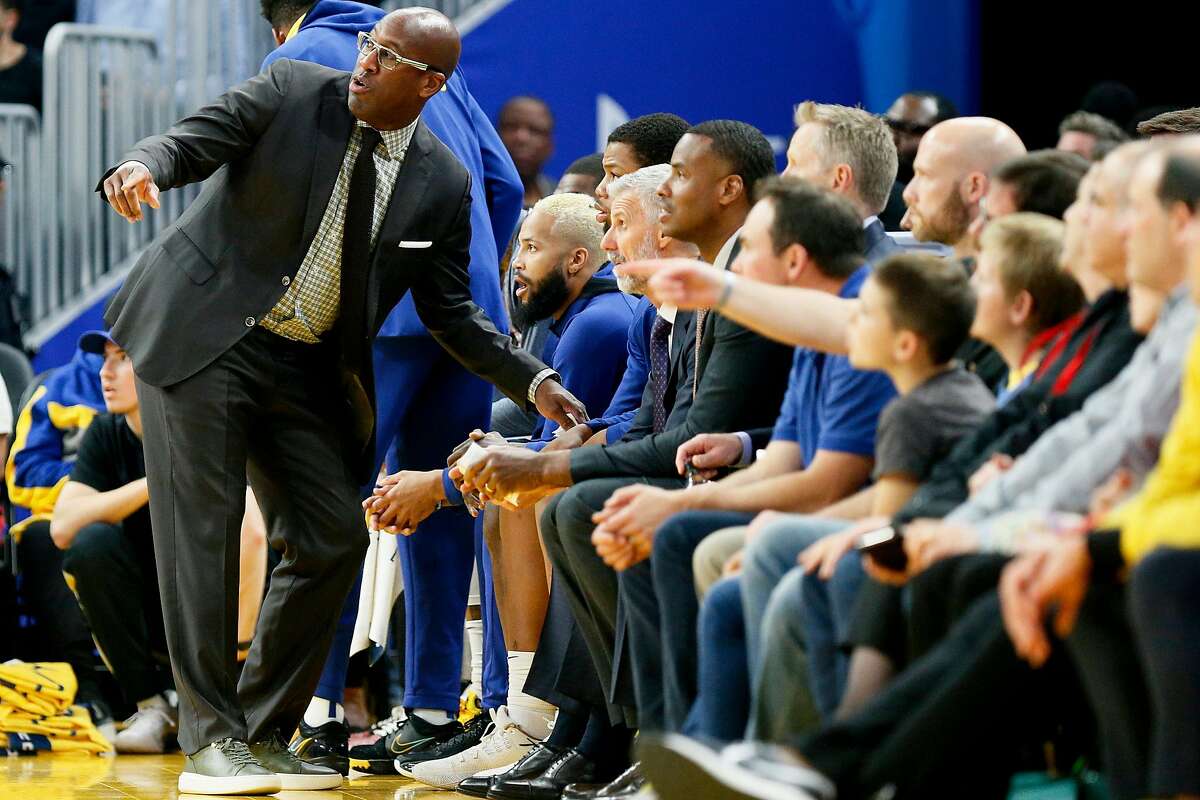 Golden State Warriors assistant coach Mike Brown talks to Warriors players on the bench in the first period of an NBA game against the Boston Celtics at Chase Center on Friday, Nov. 15, 2019, in San Francisco, Calif.