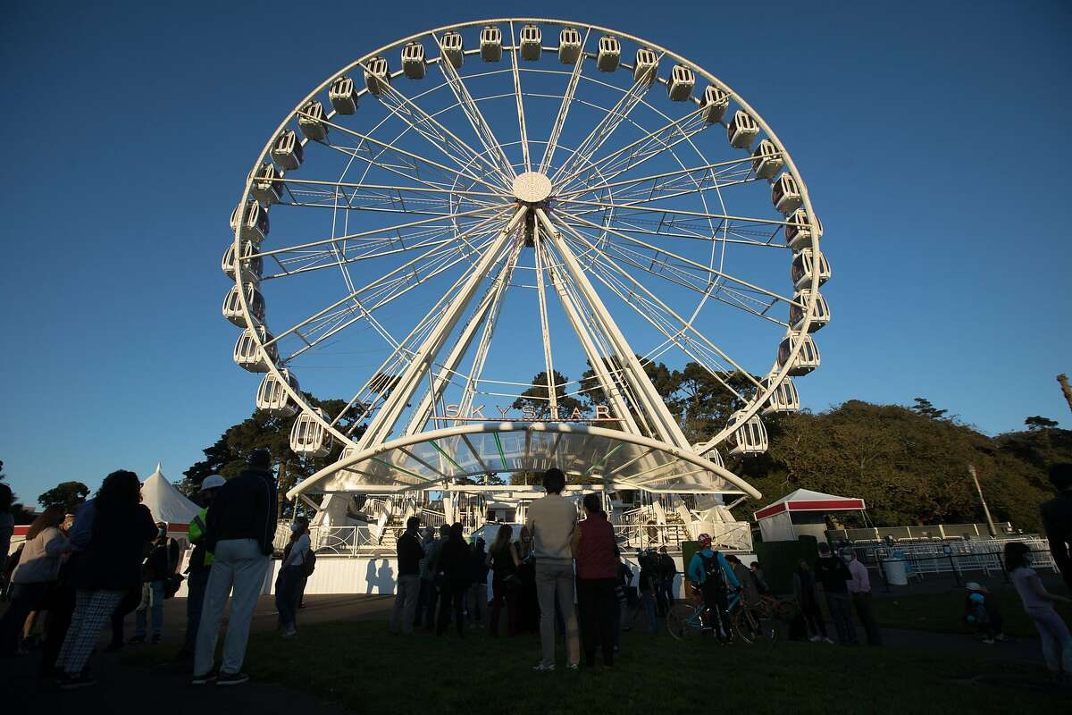 People gather for the ribbon cutting of the SkyStar Observation Wheel at the Golden Gate Park Music Concourse in San Francisco, California on October 20, 2020.
