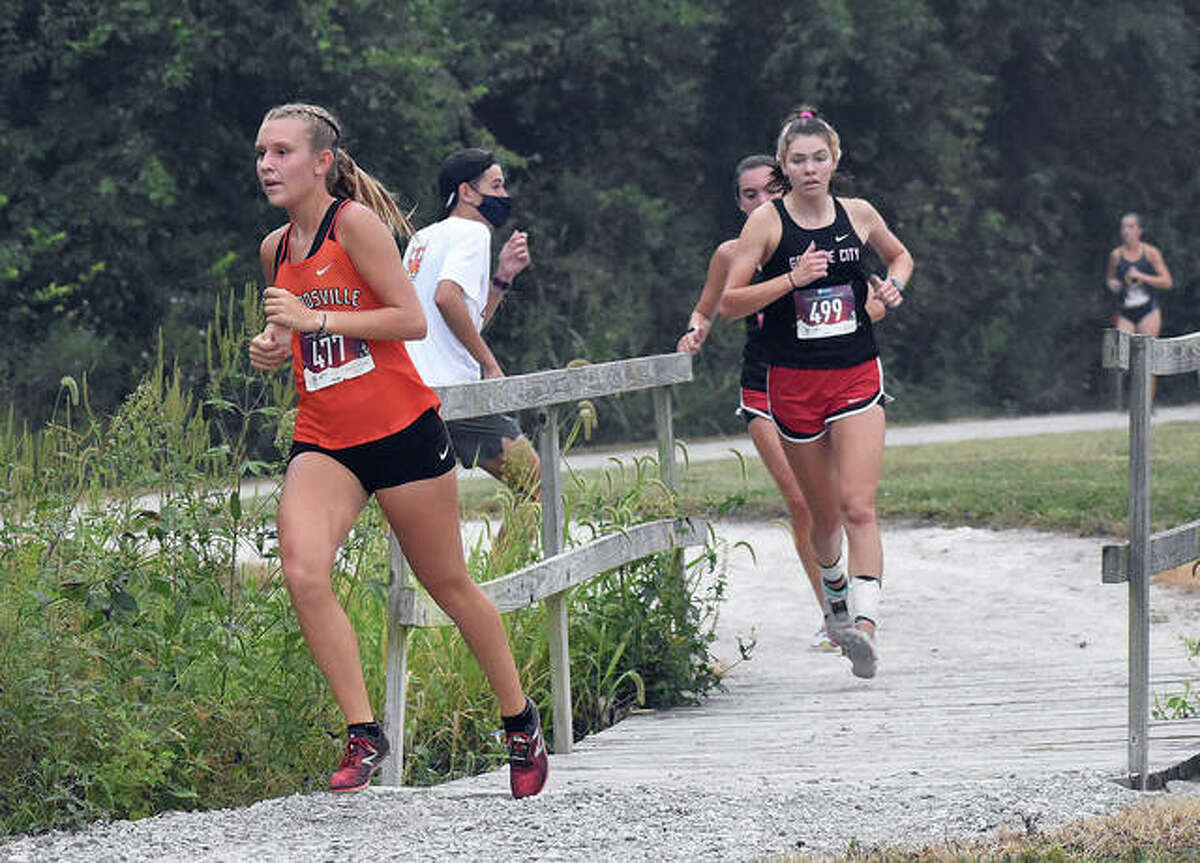 Edwardsville senior Kaitlyn Loyet crosses a bridge during the Belleville West Invitational on Sept. 12 in Belleville. Loyet took 11th place, helping the Tigers to a first-place finish.