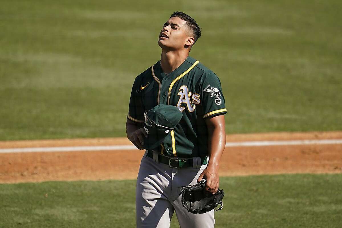 Oakland Athletics pitcher Jesus Luzardo walks to the dugout after being relieved during the fifth inning of Game 3 of a baseball American League Division Series against the Houston Astros in Los Angeles, Wednesday, Oct. 7, 2020. (AP Photo/Marcio Jose Sanchez)