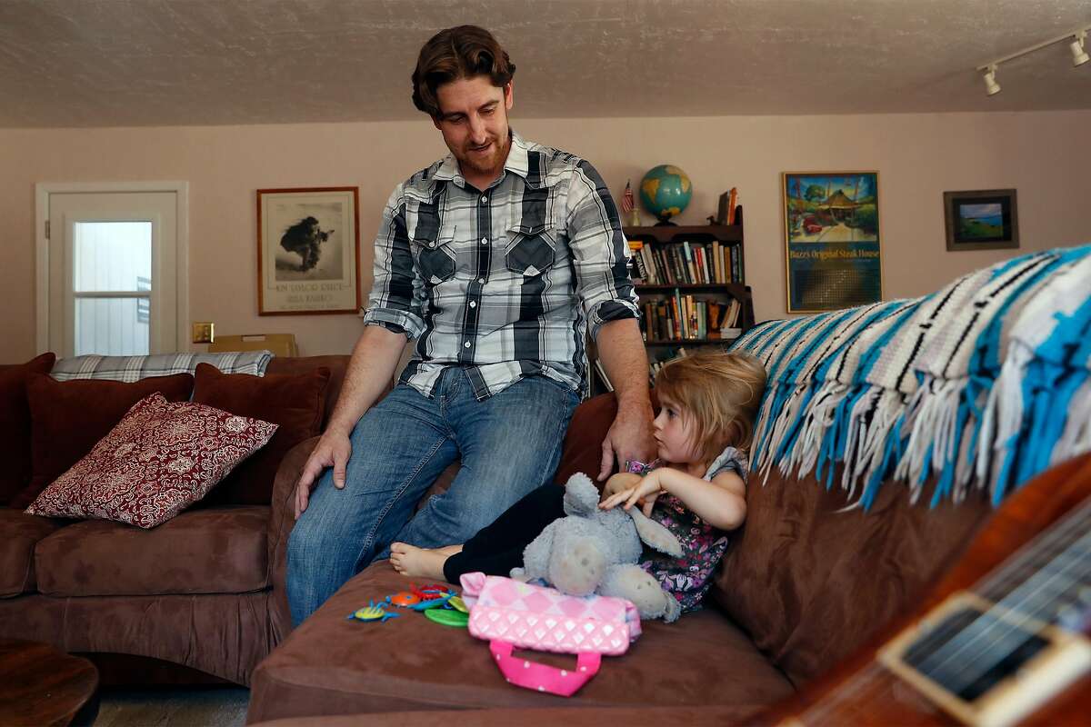 Michael Michalske spends time with his daughter, Fiona, at his in-laws’ home in Templeton on Wednesday. The pandemic has been hard on many families.