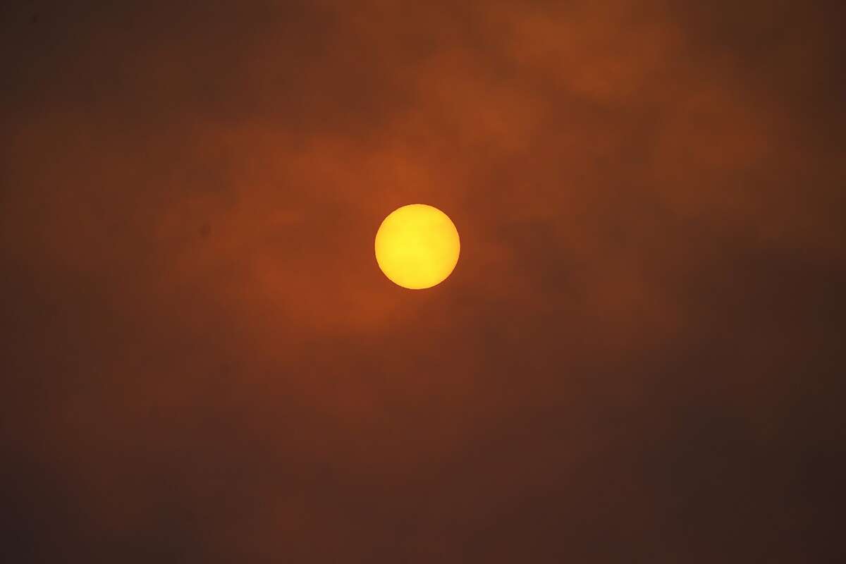 The sun is obscured by smoke along Highway 7 as several wildfires burn in the state Wednesday, Oct. 21, 2020, in Lyons, Colo. (AP Photo/David Zalubowski)