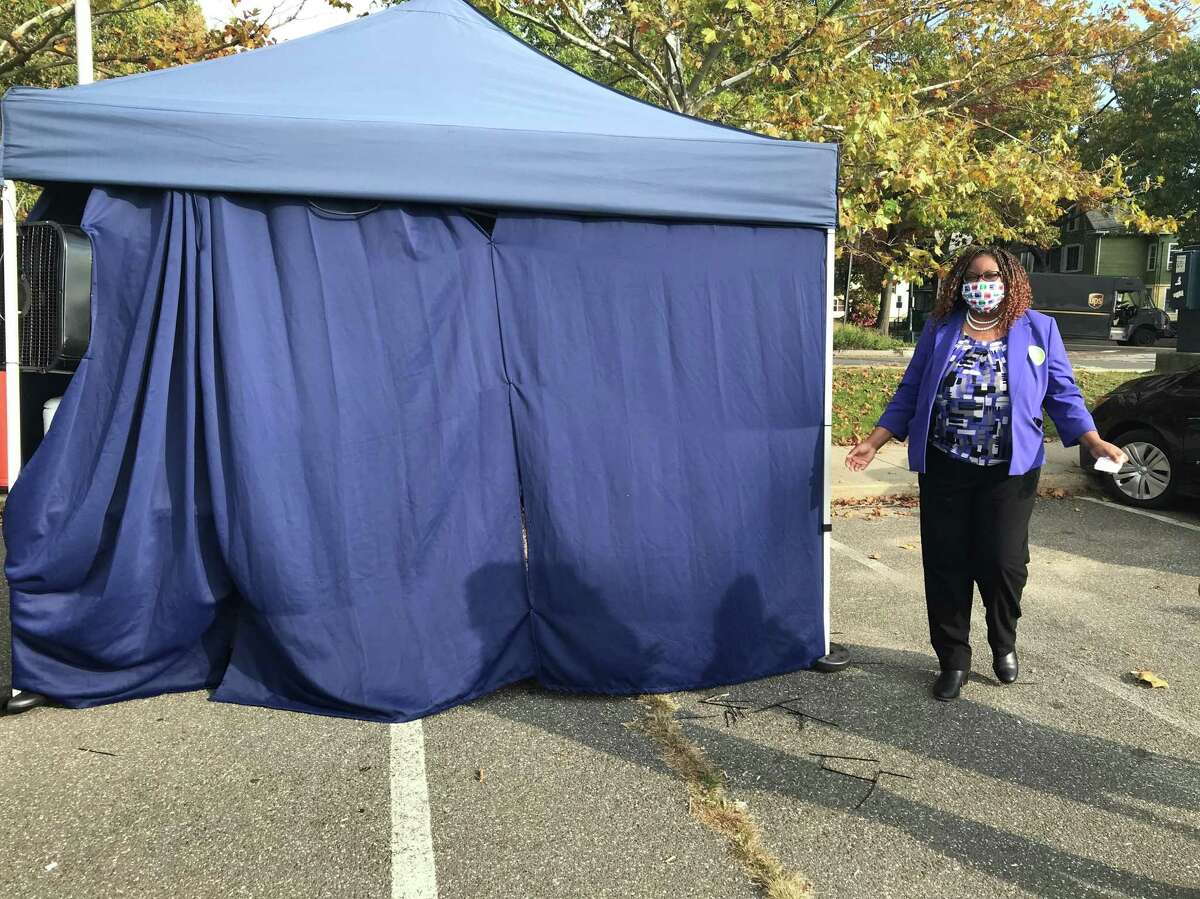 New Haven Assistant Superintendent Keisha Redd-Hannans emerges from a tent in the parking lot of King/Robinson school after receiving a nasal swab test for COVID-19 on Oct. 22, 2020.