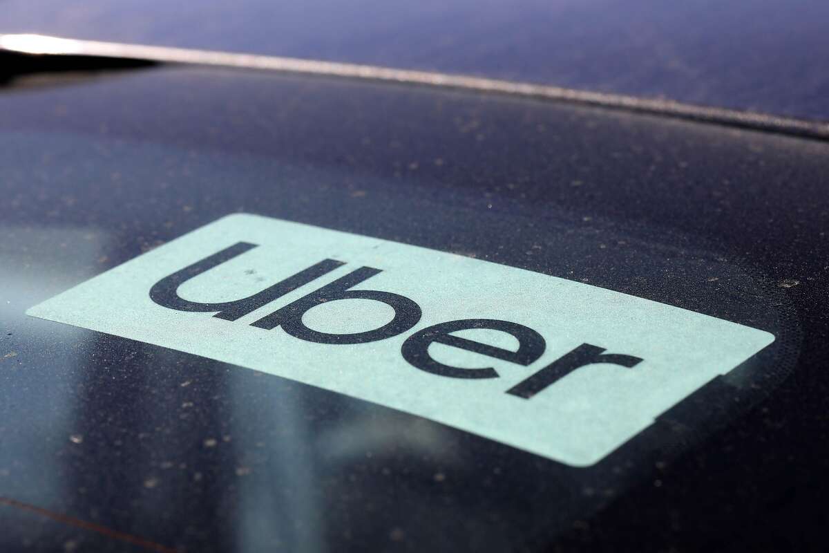 Uber driver Jorge Torres, 29, has an Uber sticker displayed on his car as he waits at a Shell gas station near the Oakland International Airport on Wednesday, October 21, 2020, in Oakland, Calif. The California Supreme Court let stand a decision that found Uber and Lyft drivers in the state should have been employees prior to the passage of Proposition 22.