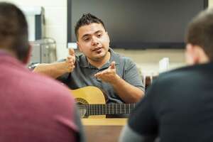 Music therapist Omar Reyna from the Harris County Department of Education uses his guitar and music to work with students needing assistance. Cypress Fairbanks ISD has one of the largest contingents of music therapists in a school district.