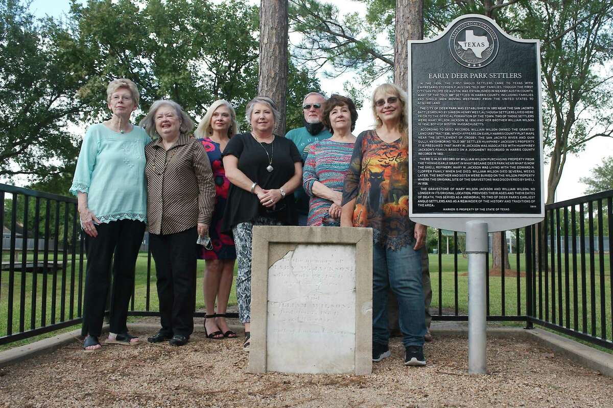 Members of the Deer Park Historical Committee stand by a historical marker and headstone set in memory of early Deer Park residents Mary W. Jackson and William Wilson during a dedication ceremony Tuesday at Dow Park.