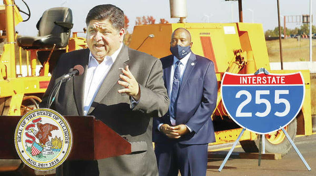Standing on Interstate-255 Thursday, south of the I-64 interchange, Gov. J.B. Pritzker congratulates construction workers on completing the renovations and repaving of the interstate south to Illinois 15 ahead of schedule.