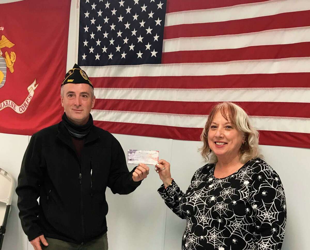 Eric Sullivan (left), director of Manistee Veterans Affairs, is presented a check by Pati Potes, president of the Manistee American Legion Auxiliary. (Courtesy photo)