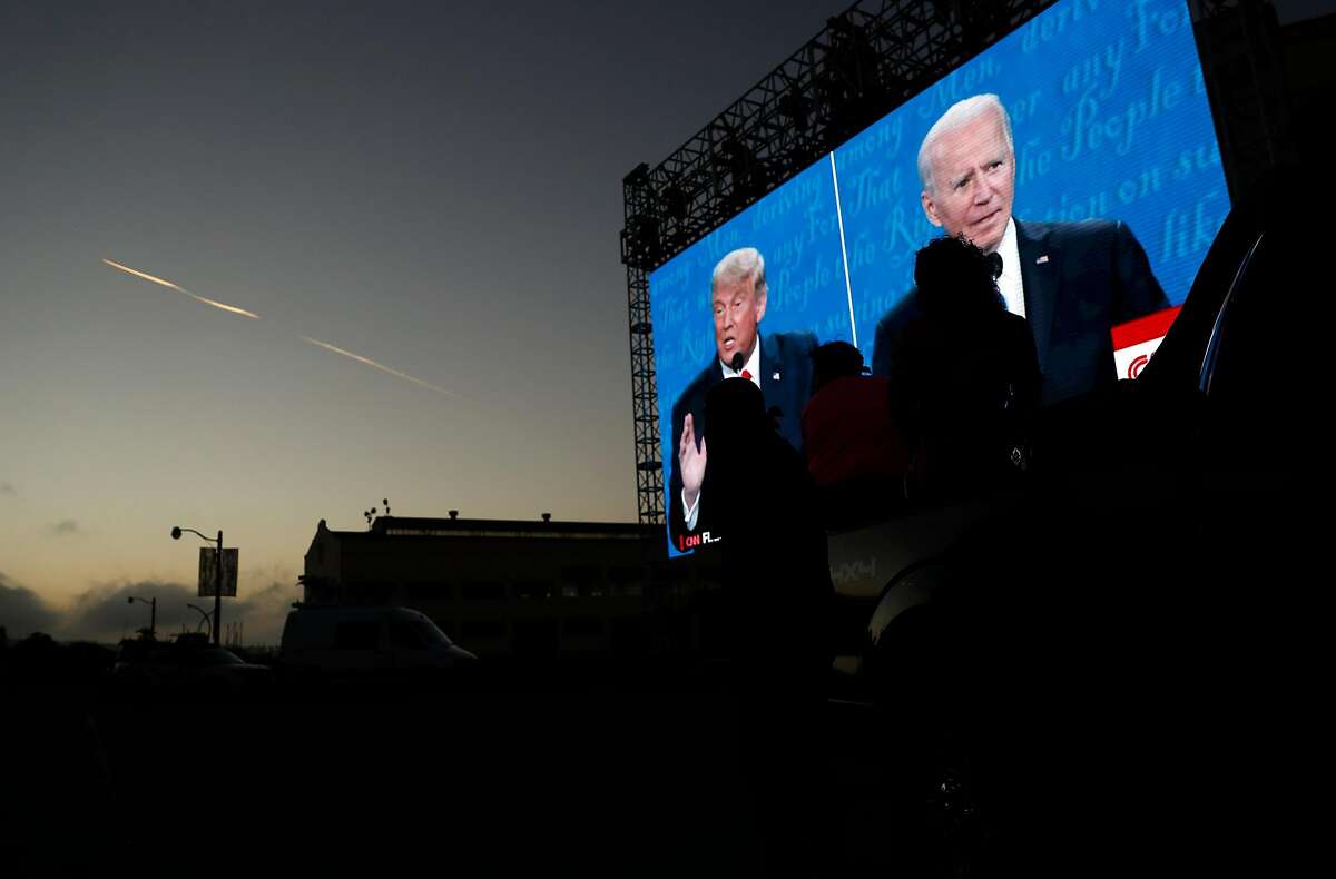 The final US Presidential debate between President Donald J. Trump and former Vice President Joe Biden is shown on a video screen at Fort Mason in San Francisco, Calif., on Thursday, October 22, 2020. The drive in debate watch party was organized by businessman Manny Yekutiel.